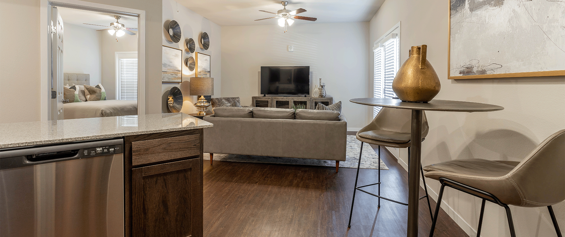 a kitchen and living room with a couch and a tv